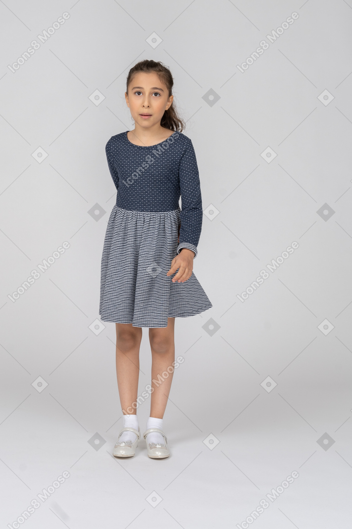 Front view of a girl hiding one hand behind her back