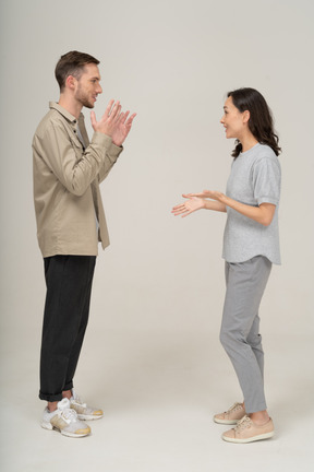 Side view of young couple speaking to each other