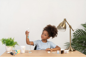 Good looking cute girl doing science at the table