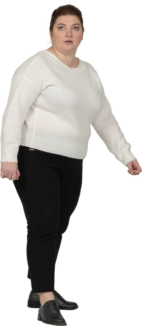 Front view of a plump woman in casual clothes looking at camera
