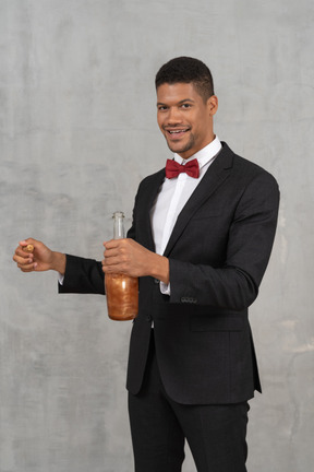 Young man holding a cork stopper and a bottle