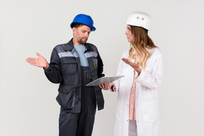 Female and male engineer colleagues discussing some work stuff