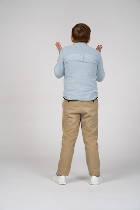 Rear view of a boy explaining something