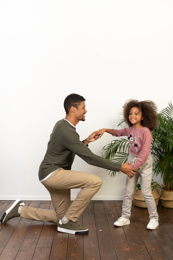 Young man dances with his daughter