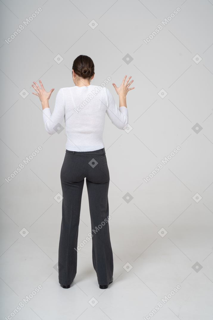 Back view of a woman with raised hands