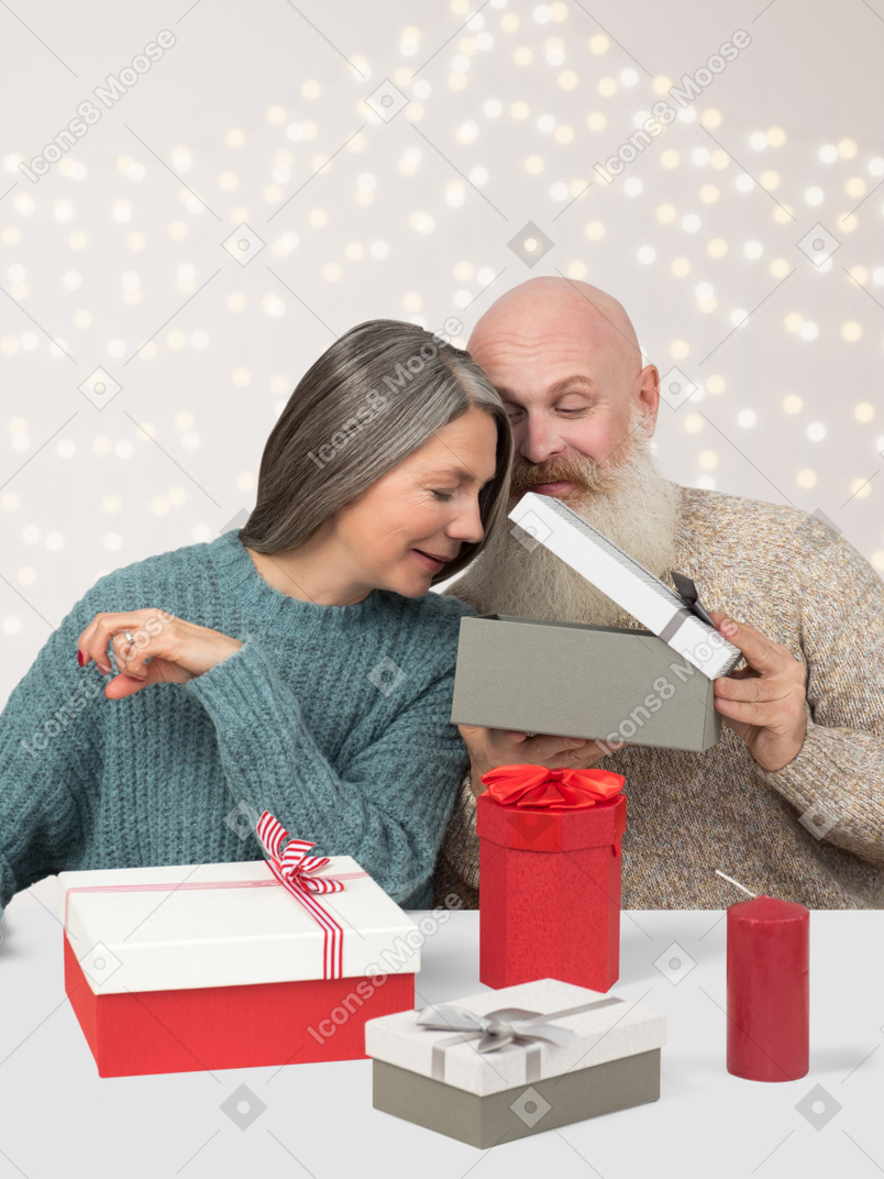 Senior couple exchanging christmas gifts