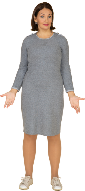Front view of a woman in grey dress looking at camera