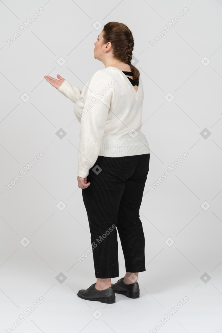 Plump woman in casual clothes sending air kiss