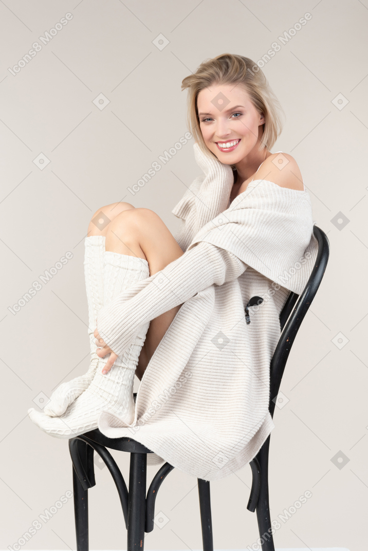 Young woman in comfy home clothes sitting on chair