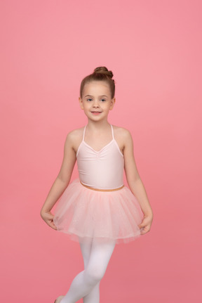 Little ballerina holding tutu with her hands