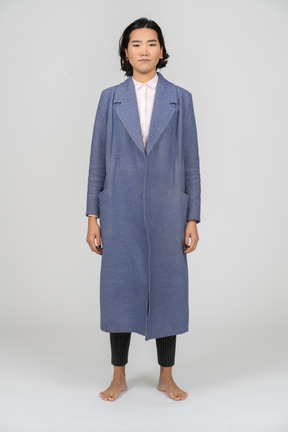 Front view of an unhappy woman in blue coat