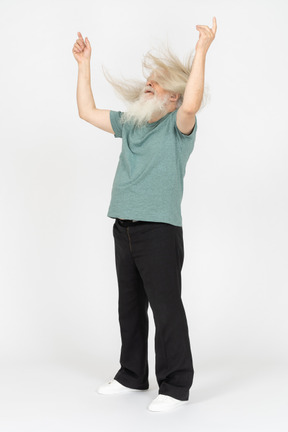 Three-quarter view of old man shaking head and raising hands