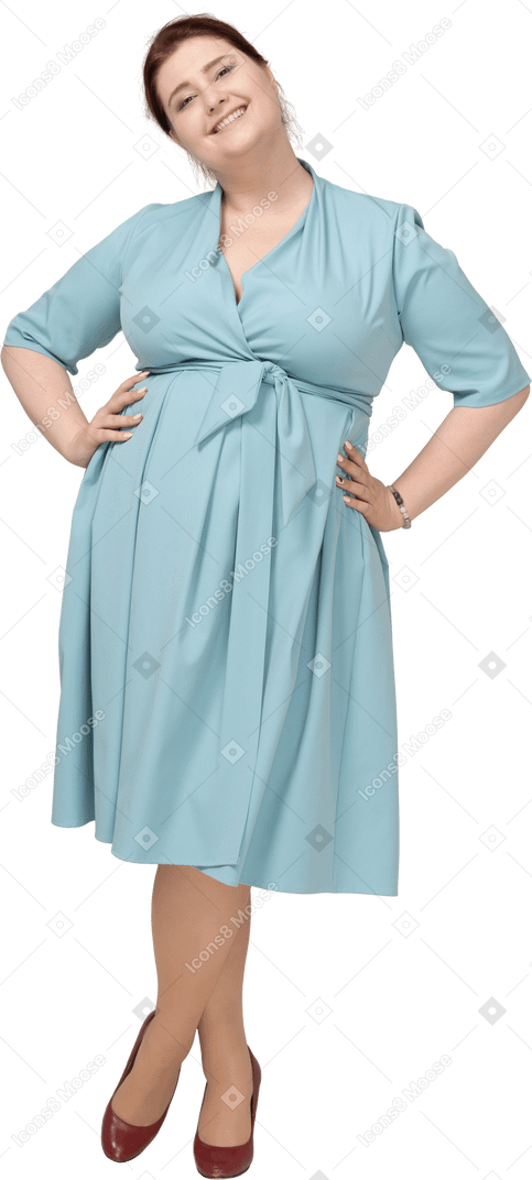 Front view of a woman in blue dress posing with hands on hips