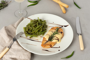 Plat de morceaux de saumon avec sauce et haricots verts