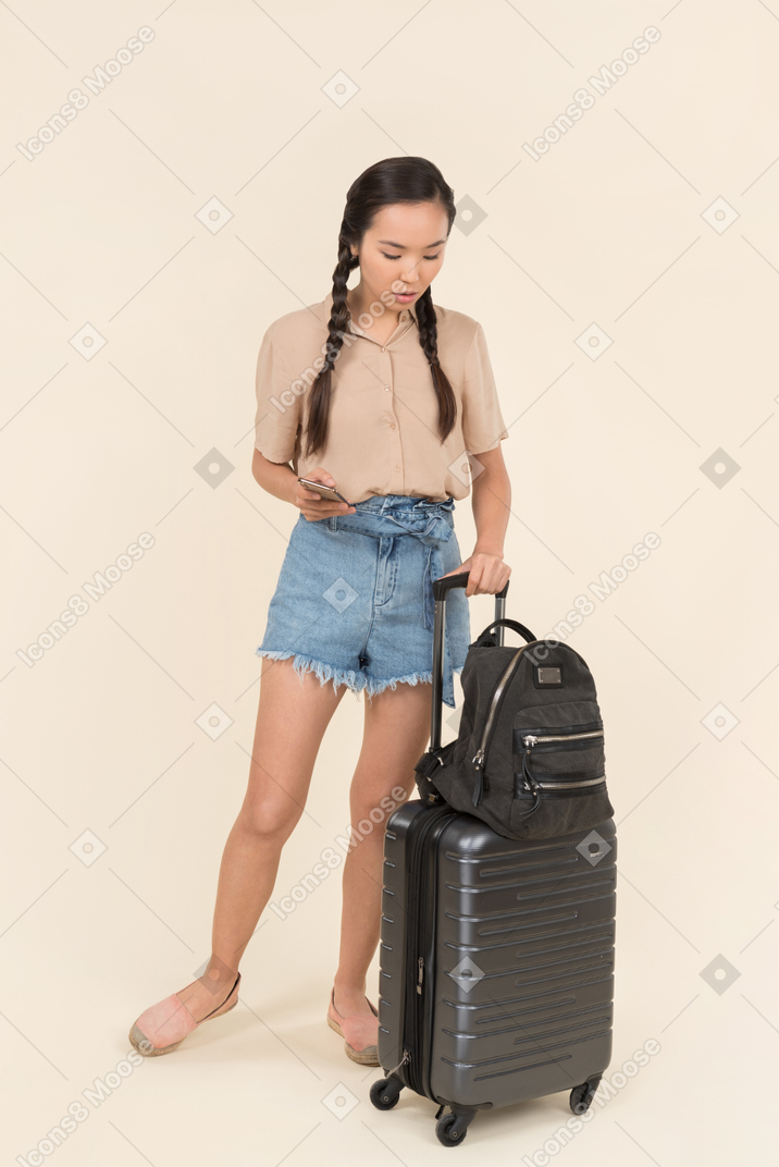 Young female traveler looking down