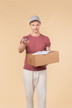 Delivery guy holding box and handling a pen