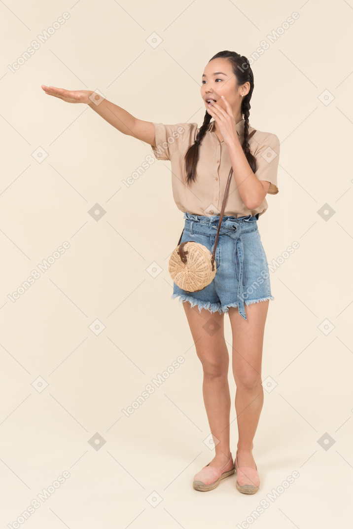 Young asian woman hailing a taxi