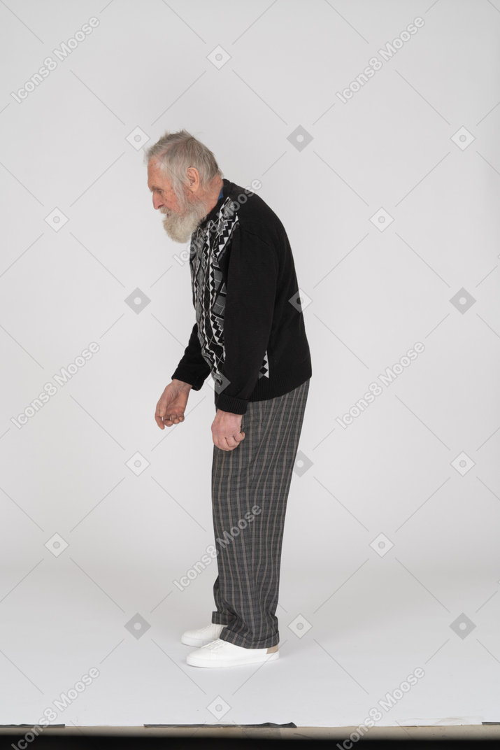 Side view of old man looking down and communicating