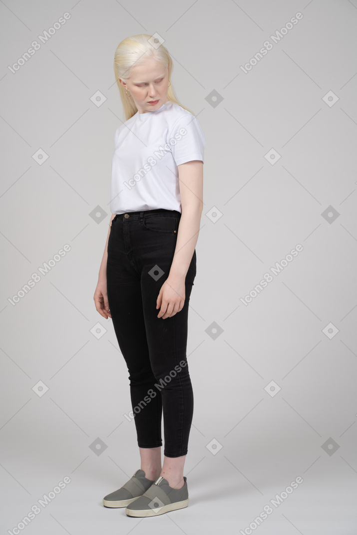 Teenage girl in casual clothes with her head down