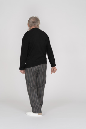 Back view of elderly man turning away from camera