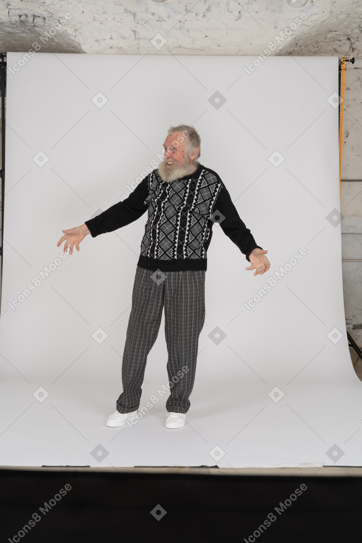 Front view of joyful elderly man standing with open arms