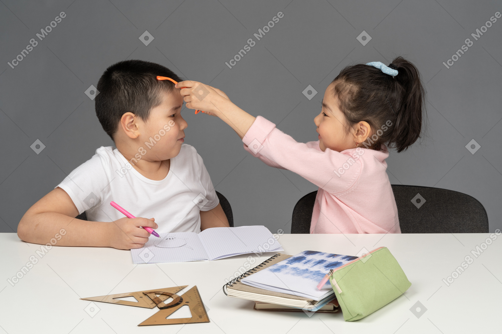 Little girl putting sunglasses on her brother