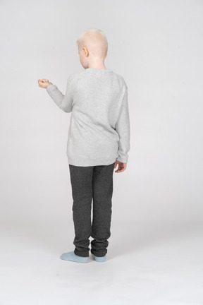 Back view of a boy with clenched fist