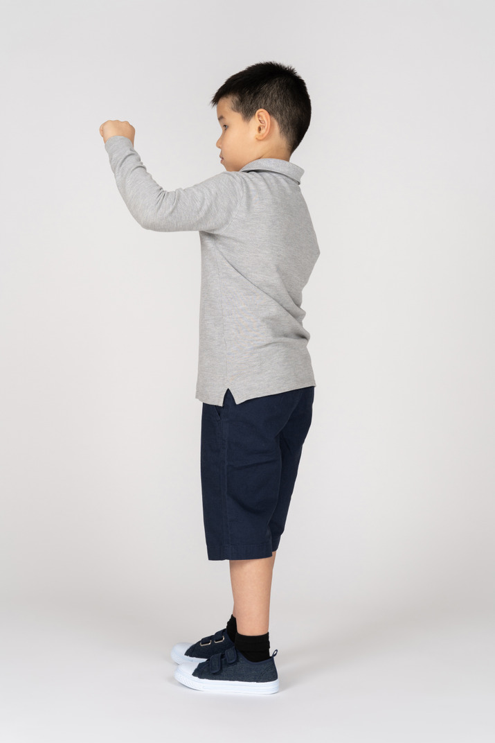 Boy measuring something small in profile