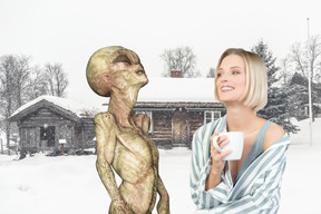 Woman with mug standing next to alien