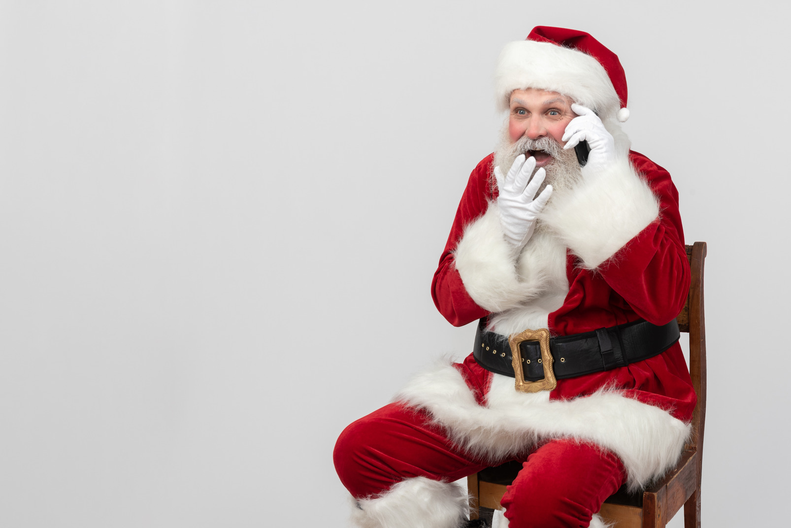 Laughing santa claus talking on the phone
