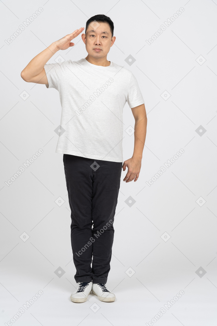 Front view of a man in casual clothes saluting with hand
