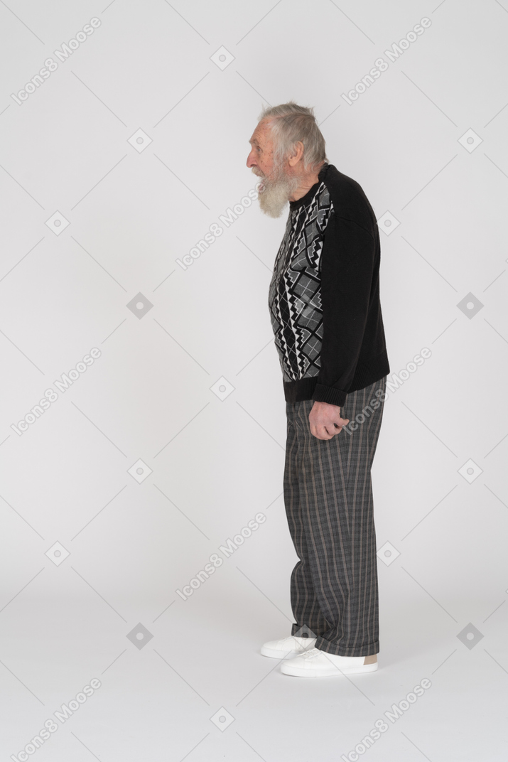 Side view of an old bearded man standing with open mouth