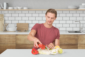 Man taking vegetables out of mesh bag