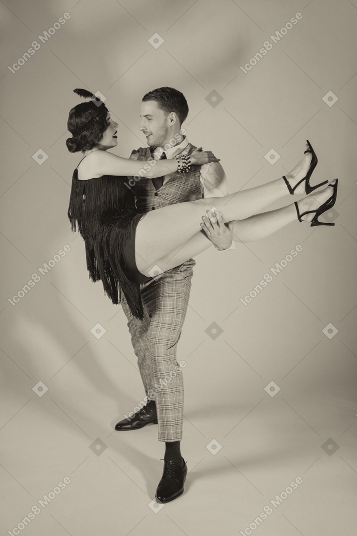 Young man lifting his beautiful dance partner