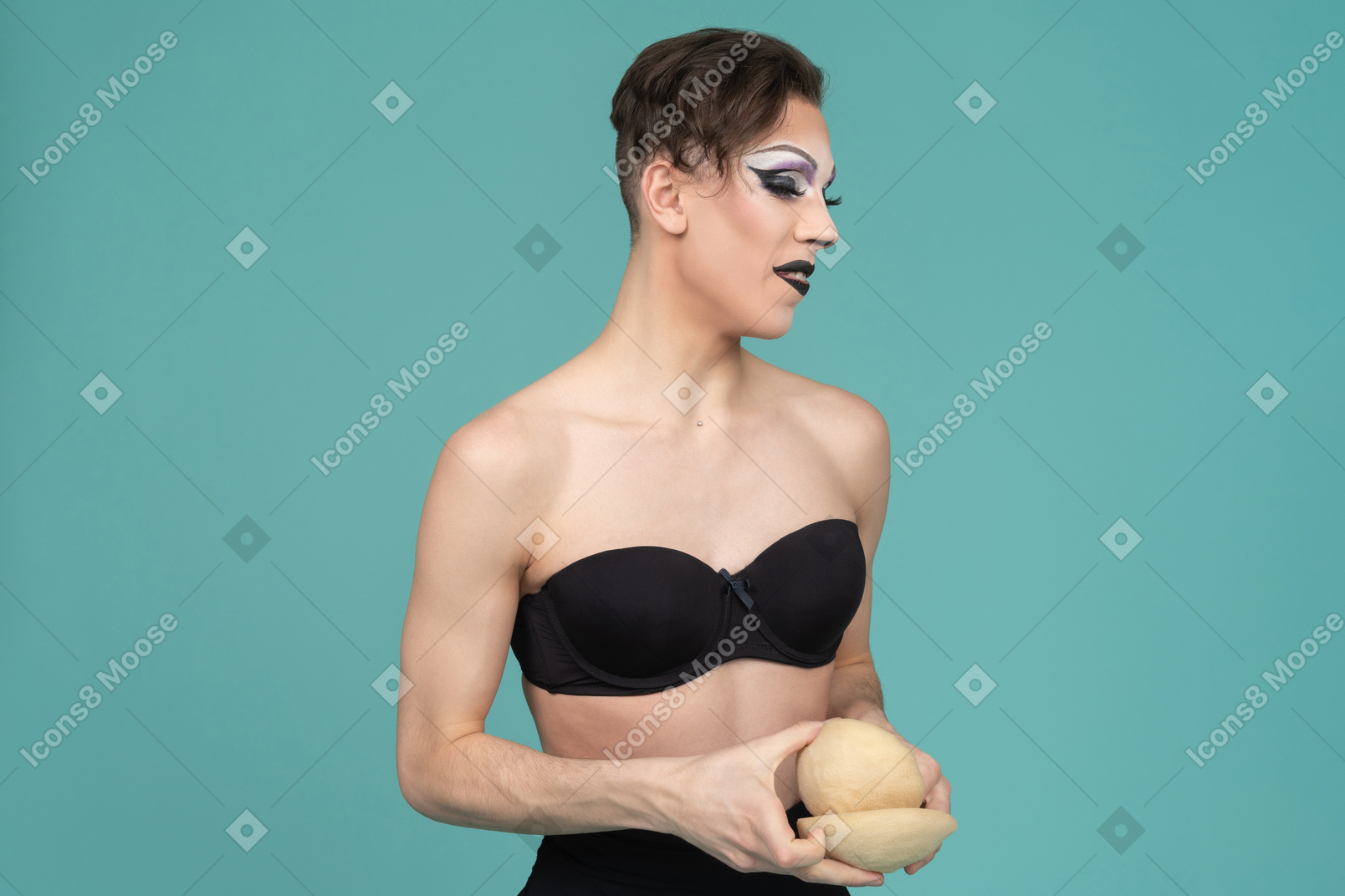 Drag queen holding bra inserts