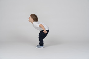 Side view of a little boy getting ready to jump