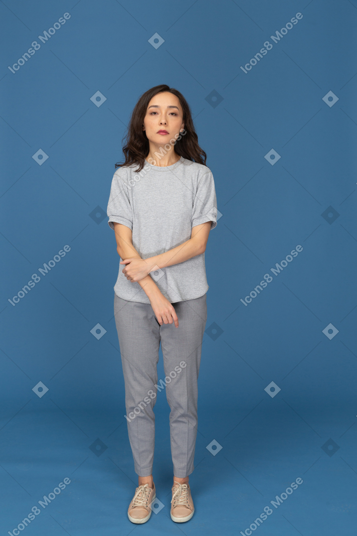A woman standing in front of a blue background