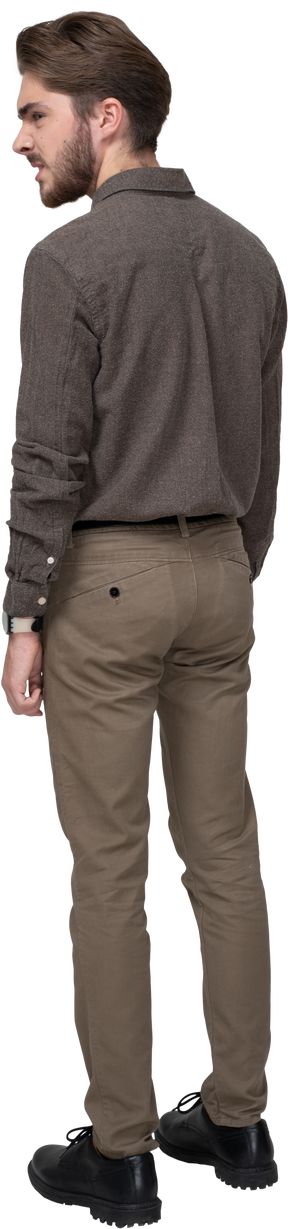 Three-quarter back view of a furious man in office clothing clenching fists