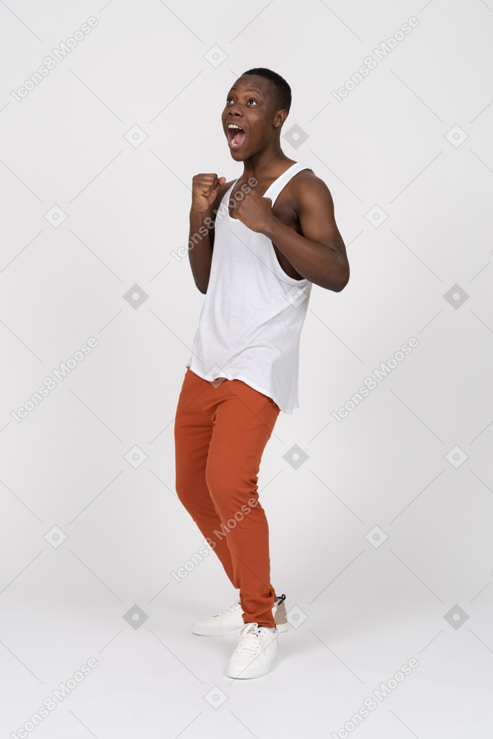 Young man looking up and screaming with excitement