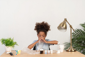 Good looking cute girl doing science at the table