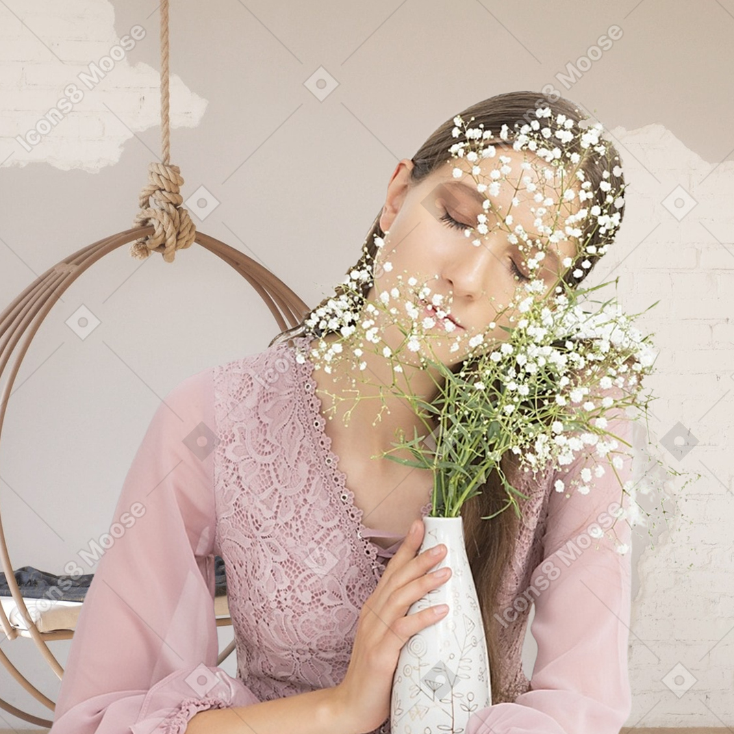 A woman sitting on a chair holding a vase with flowers in it