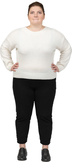 Plump woman in casual clothes looking at camera