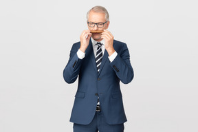 Handsome middle aged man with a cigar having a conversation