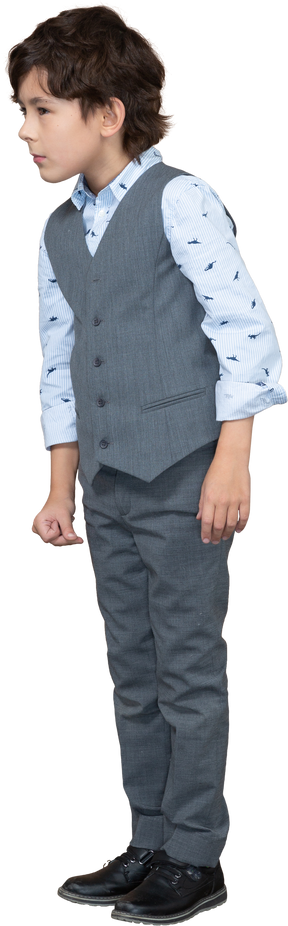 Front view of a cute boy in grey suit looking at something with interest