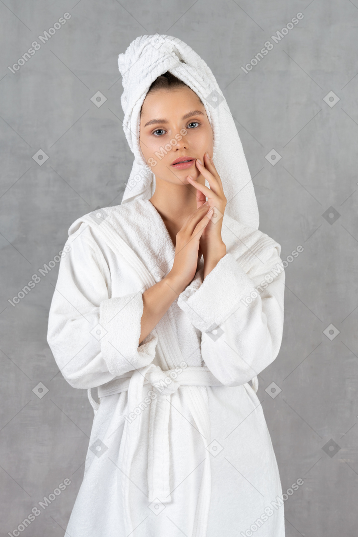 Woman in bathrobe holding her hands together