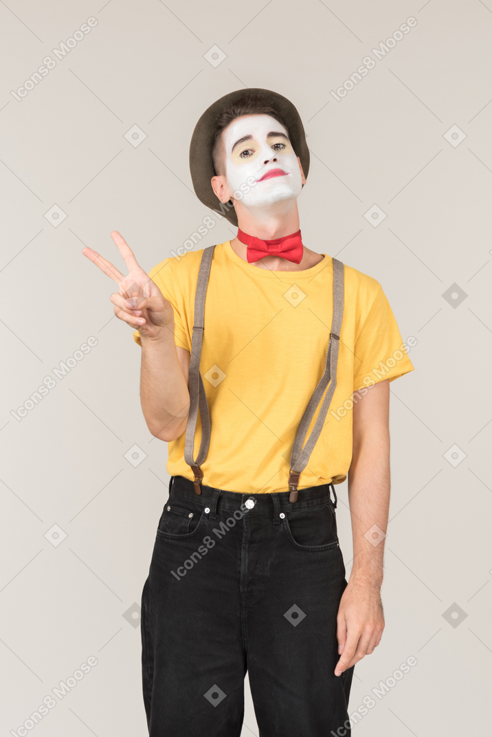 Male clown showing peace signs