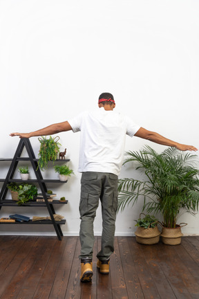 Good looking young man posing on the background of the apartment