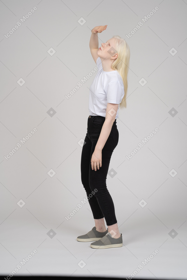 Side view of girl covering face from light