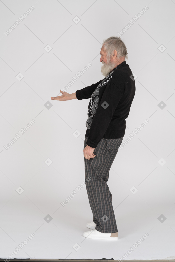 Side view of old man gesturing with hand