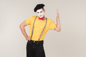 Male mime showing stop gesture